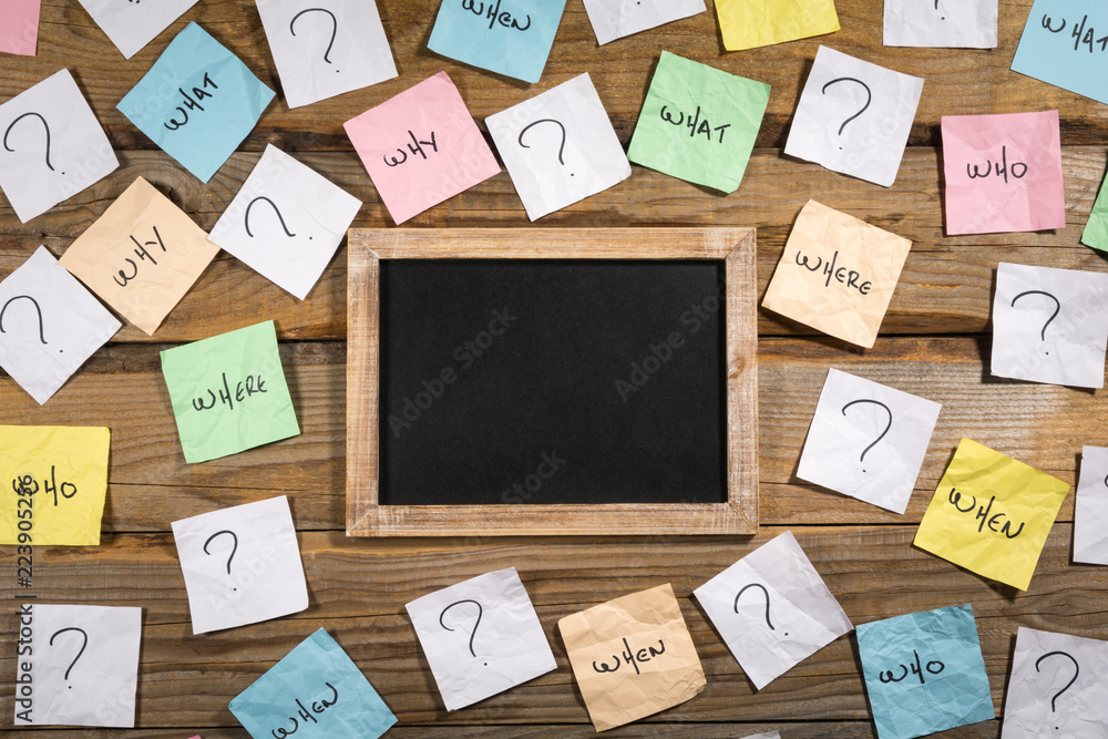 Who, why, what, when, how, where and question marks on crumpled ...