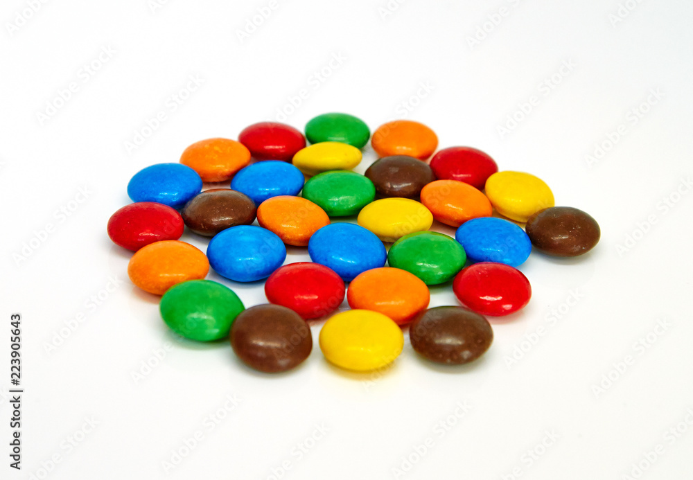 colorful chocolate buttons on a white background colorful chocolate buttons on a white background