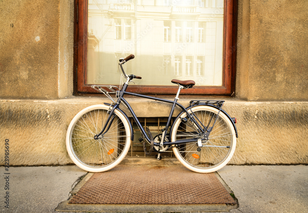 A beautiful city bike fastened to a metal fence.