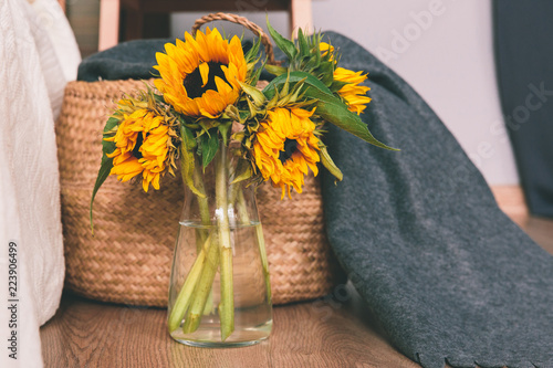 Fototapeta Naklejka Na Ścianę i Meble -  Yellow sunflowers in vase on floor of the room