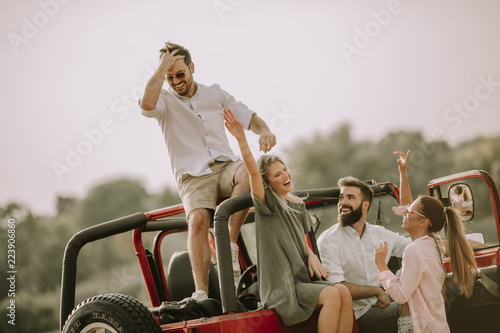 Young people having fun in convertible car by river © BGStock72