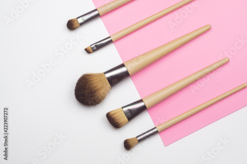 Make up brush on white and pink background