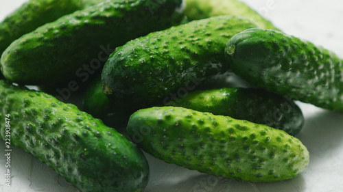 Closeup of textured pimply green cucumbers lying in small heap in soft daylight