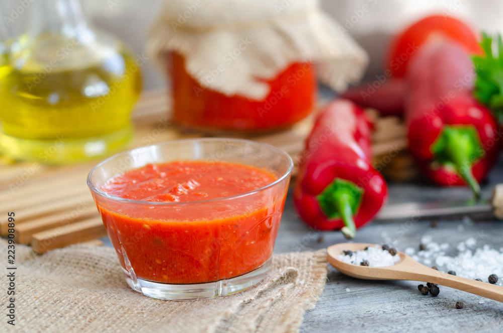 Mixed tomatoes and chilli sauce in bowl on table. Mixed tomatoes and chilli sauce in bowl on table.