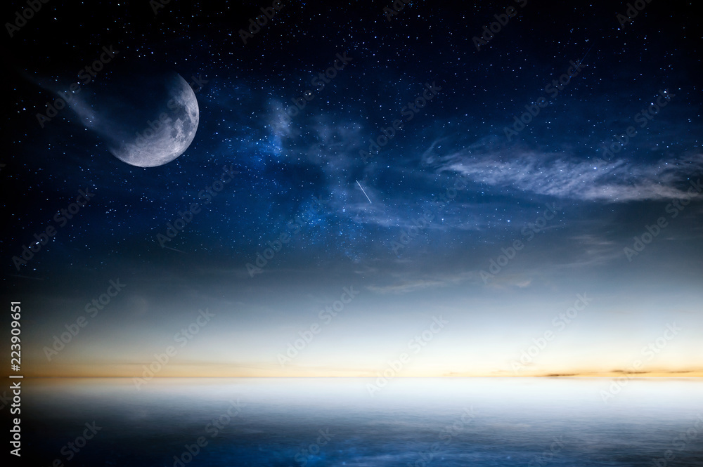 Calm sea sunset over night sky with stars and moon. Moon on this image furnished by NASA