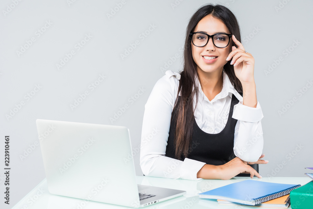Young pretty business woman with notebook in the office isolated on white background Young pretty business woman with notebook in the office isolated on white background