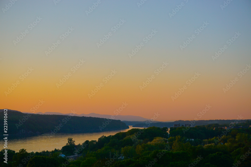 Poughkeepsie, New York: View of sunset over the Hudson River, with the Catskill Mountains in the background, from the Walkway Over the Hudson.