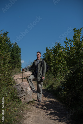 portarit of hiker standing on dirt path 
