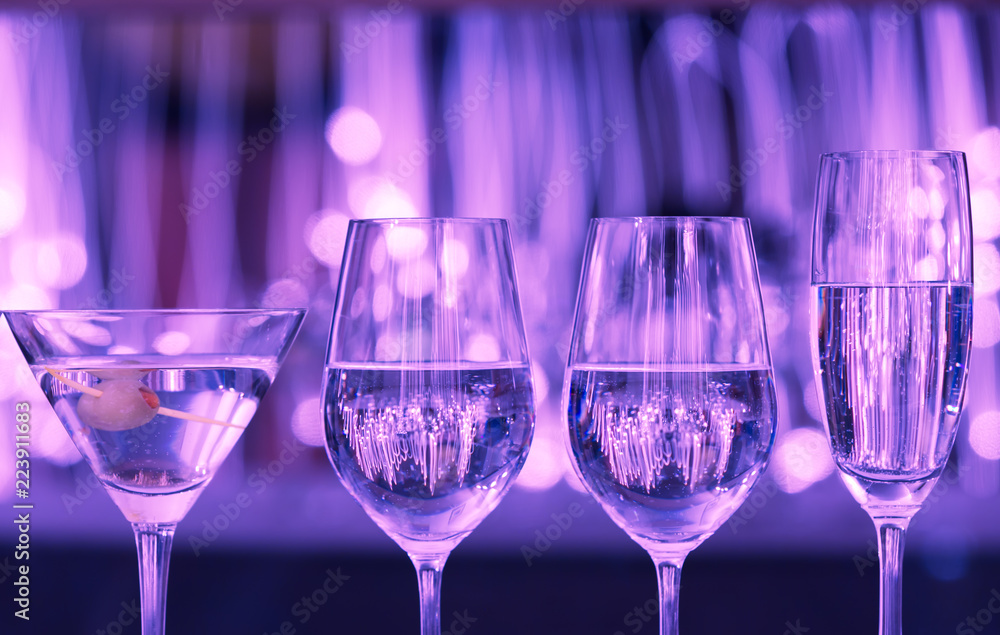 Row of Alcohol drinks against purple lights. Row of Alcohol drinks against purple lights.