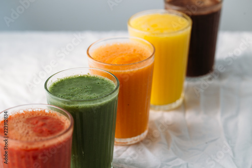 Colorful smoothies in glass with fresh tropical fruit and superfoods
