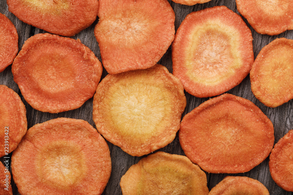 Aerial crispy snack from carrot processed by vacuum drying, top view Aerial crispy snack from carrot processed by vacuum drying, top view