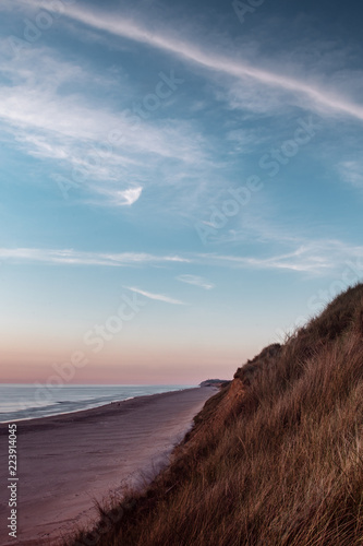 panorama of the danish coastline shore at colorful and beautiful sunset. Løkken in North Jutland in Denmark, Skagerrak, North Sea