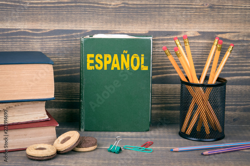 learn spanish concept. Book on a wooden background photo