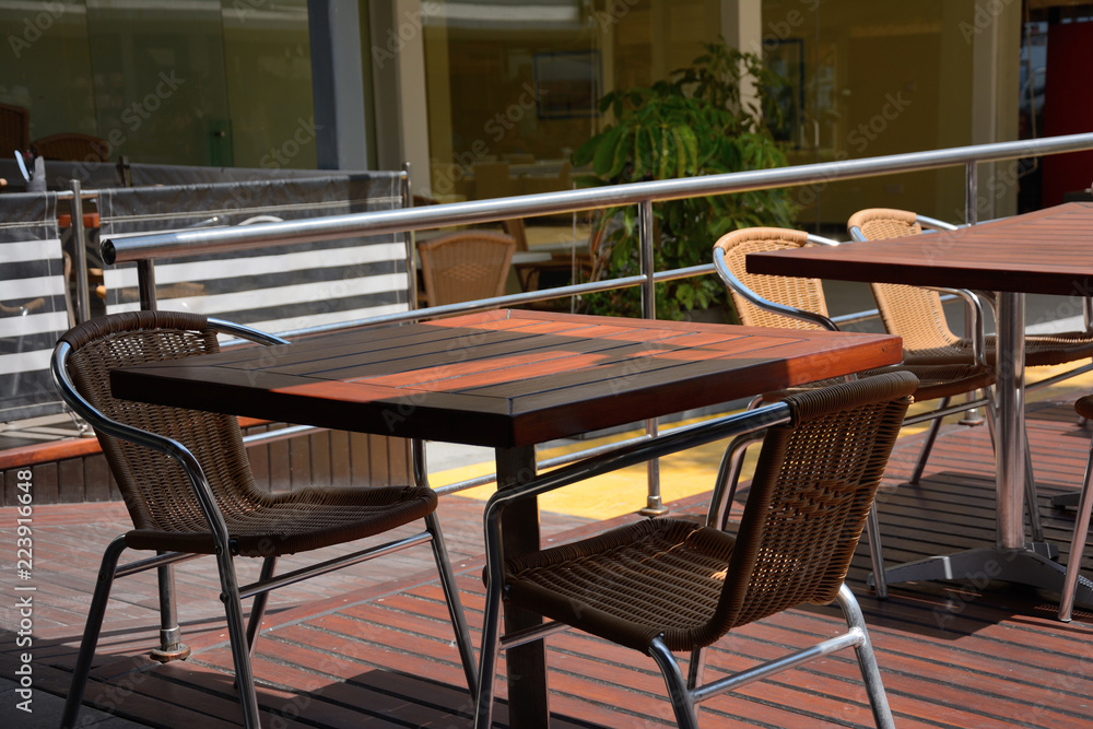 Wooden table and chairs in summer cafe. Free