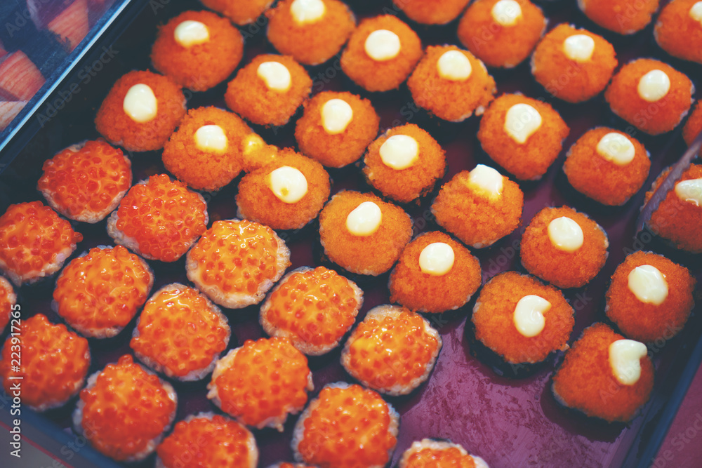 Fototapeta premium Japanese sushi arranged in a serving tray of a Japanese restaurant.