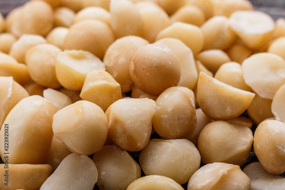 delicious macadamia nuts on a wooden rustic background delicious macadamia nuts on a wooden rustic background