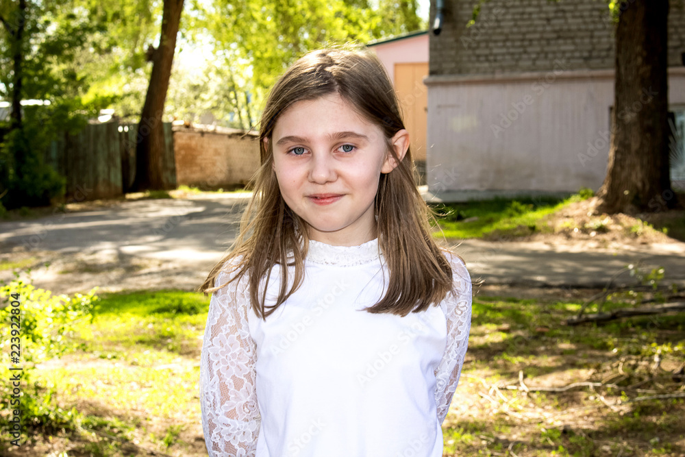 Portrait of a teenage girl, in strict clothing. The girl in the park Portrait of a teenage girl, in strict clothing. The girl in the park
