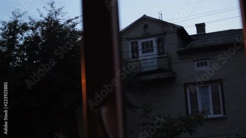 Wallpaper Mural evening outside the window in the village,Lighted street in the evening through the window Torontodigital.ca