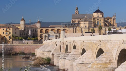 Roman bridge over Guadalquivir river, Great Mosque-Cathedral and city view of Cordoba, Andalusia, Spain photo