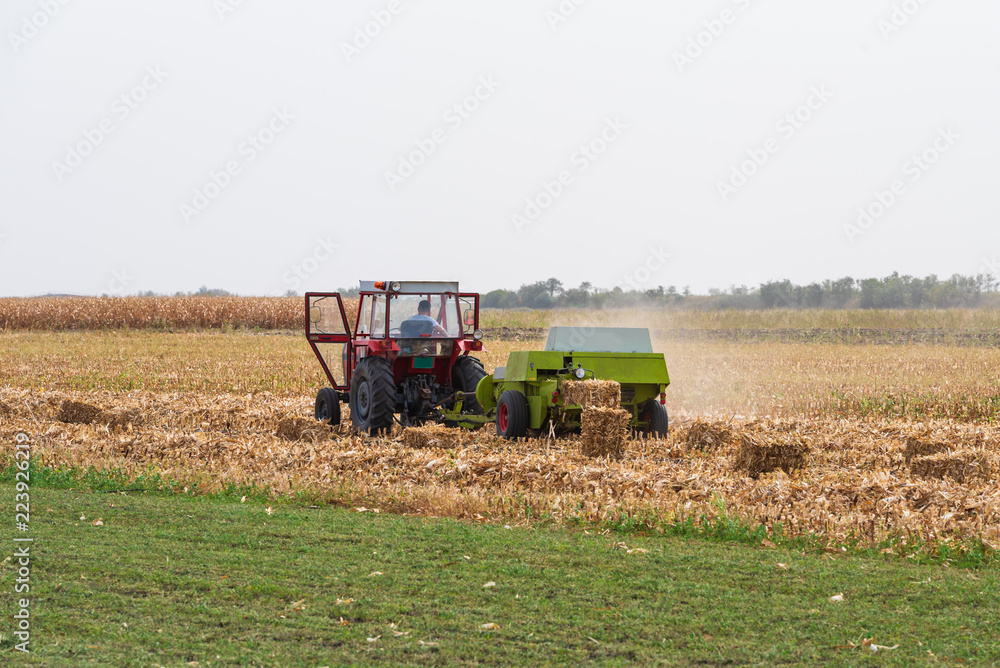Obraz premium a red tractor on a field in autumn