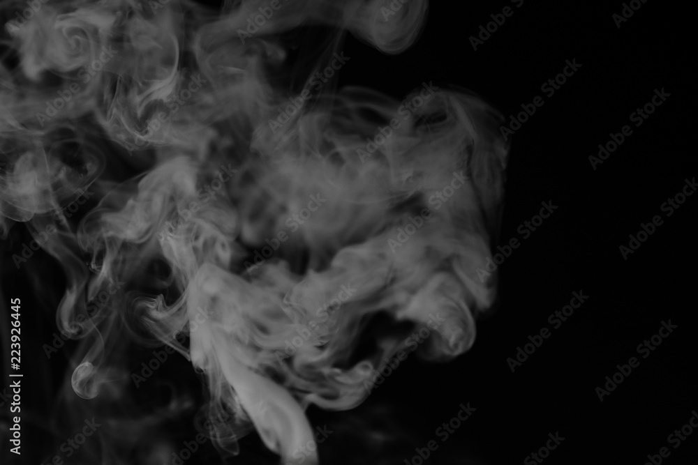 White smoke on a black background. Texture of smoke. Clubs of wh White smoke on a black background. Texture of smoke. Clubs of wh