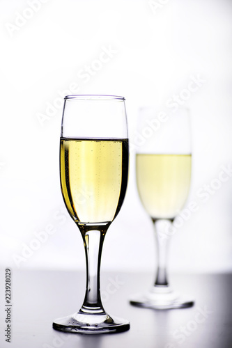 glass of white wine on a table on white background isolate