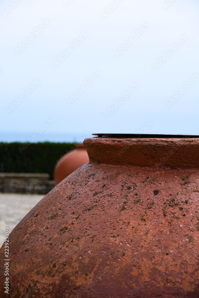 Roman pot against a brilliant pale blue sky