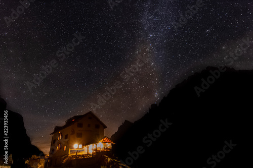 Wallpaper Mural Dolomitic mountain hut with starry sky background, South Tyrol, Italy Torontodigital.ca