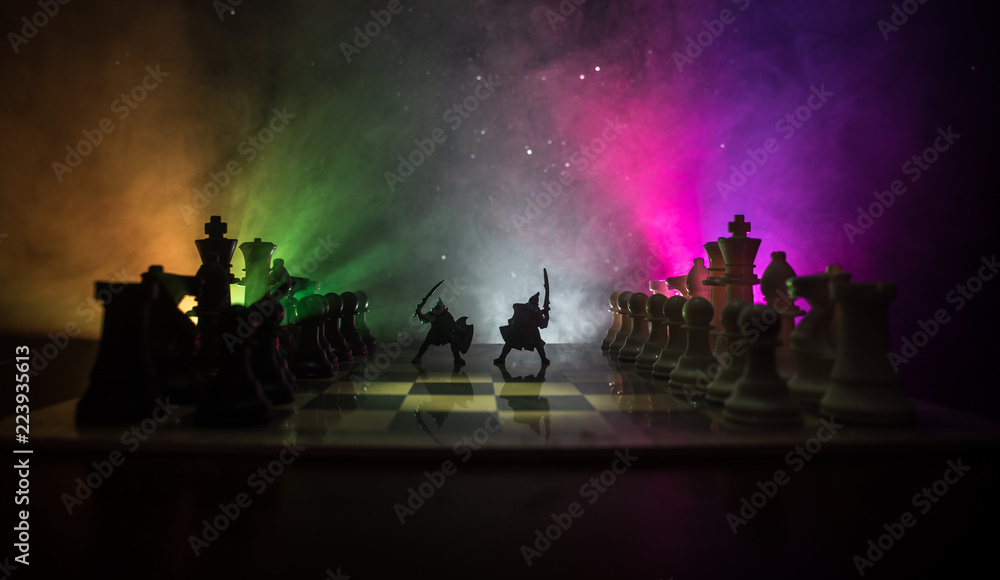 Medieval battle scene with cavalry and infantry on chessboard. Chess board game concept of business ideas and competition and strategy ideas Chess figures on a dark background Medieval battle scene with cavalry and infantry on chessboard. Chess board game concept of business ideas and competition and strategy ideas Chess figures on a dark background