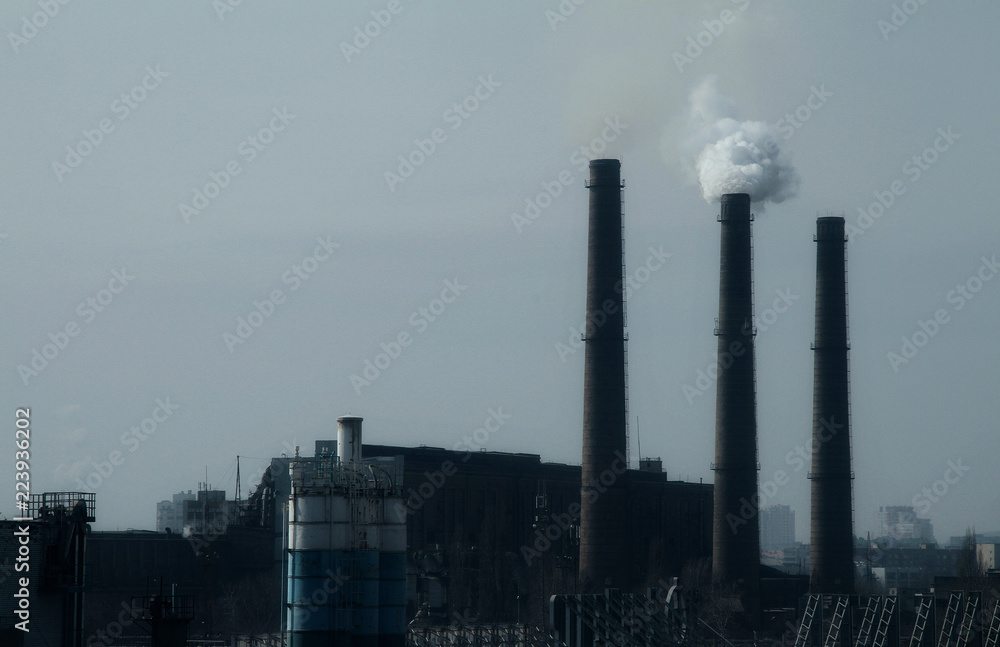 Smoke stack in working plant emitting smog and air pollution 
