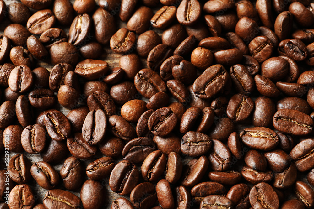 Fototapeta premium Roasted coffee beans as background, top view