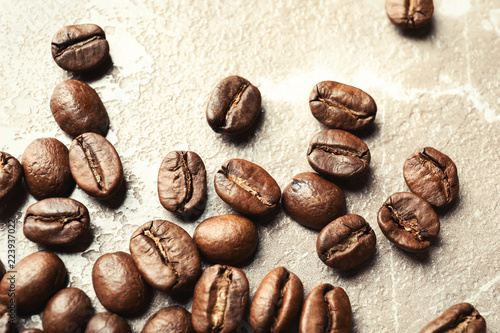 Roasted coffee beans on grey background  closeup