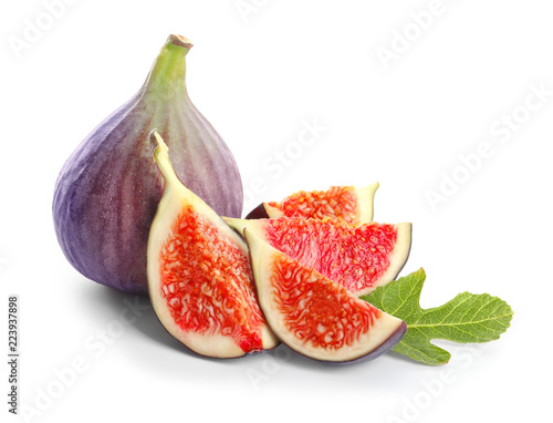 Whole and cut purple figs on white background