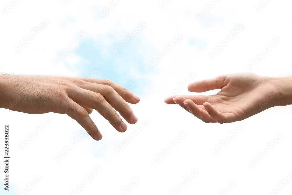 Man and woman giving each other hands on blurred background. Concept of support and help
