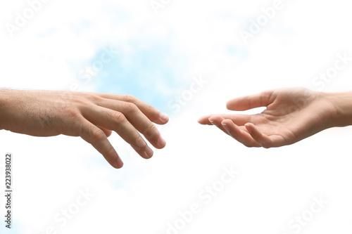 Man and woman giving each other hands on blurred background. Concept of support and help