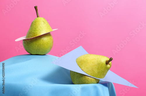 Creative composition with fresh ripe pears against color background