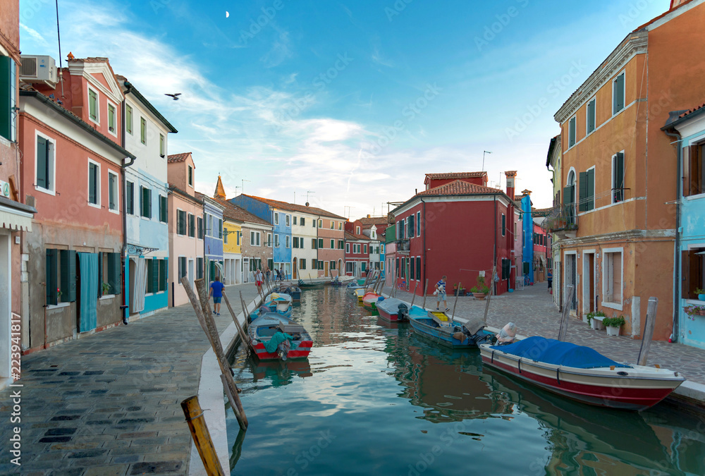 Scenery of canal and colorful vibrant fisherman village in Burano island, Venice, Italy