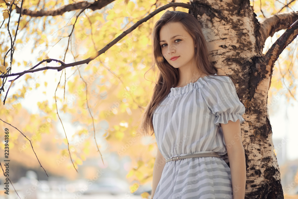 Young girl on a walk in the autumn 
