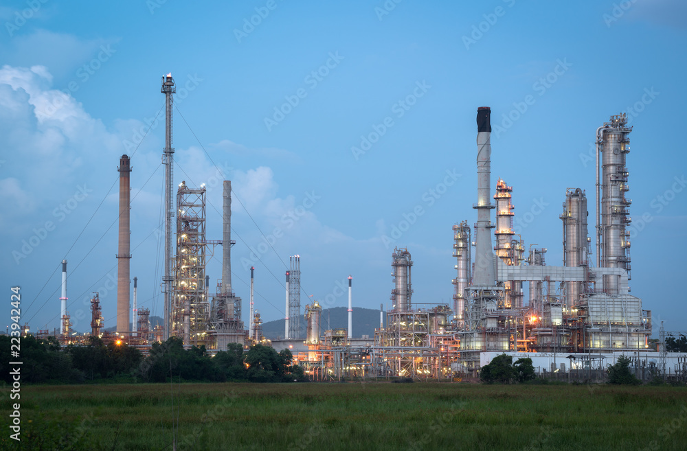 Oil refinery plant at twilight with blue sky.