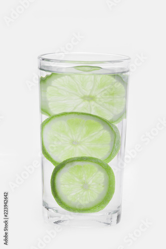 glass with water and lemon isolated on white background