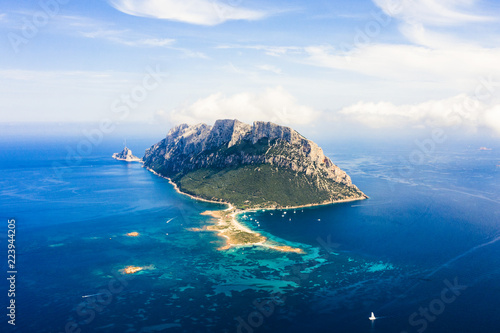 Spectacular aerial view of Tavolara's island bathed by a clear and turquoise sea, Sardinia, Italy. photo