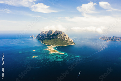 Spectacular aerial view of Tavolara's island bathed by a clear and turquoise sea, Sardinia, Italy.