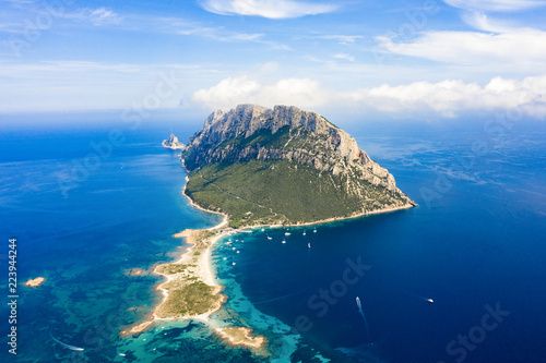 Spectacular aerial view of Tavolara's island bathed by a clear and turquoise sea, Sardinia, Italy.
