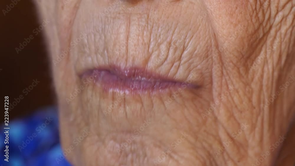 Close-up shot of an elderly woman chewing Close-up shot of an elderly woman chewing