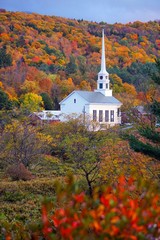 A church surrounded by fall foliage in Stowe, Vermont