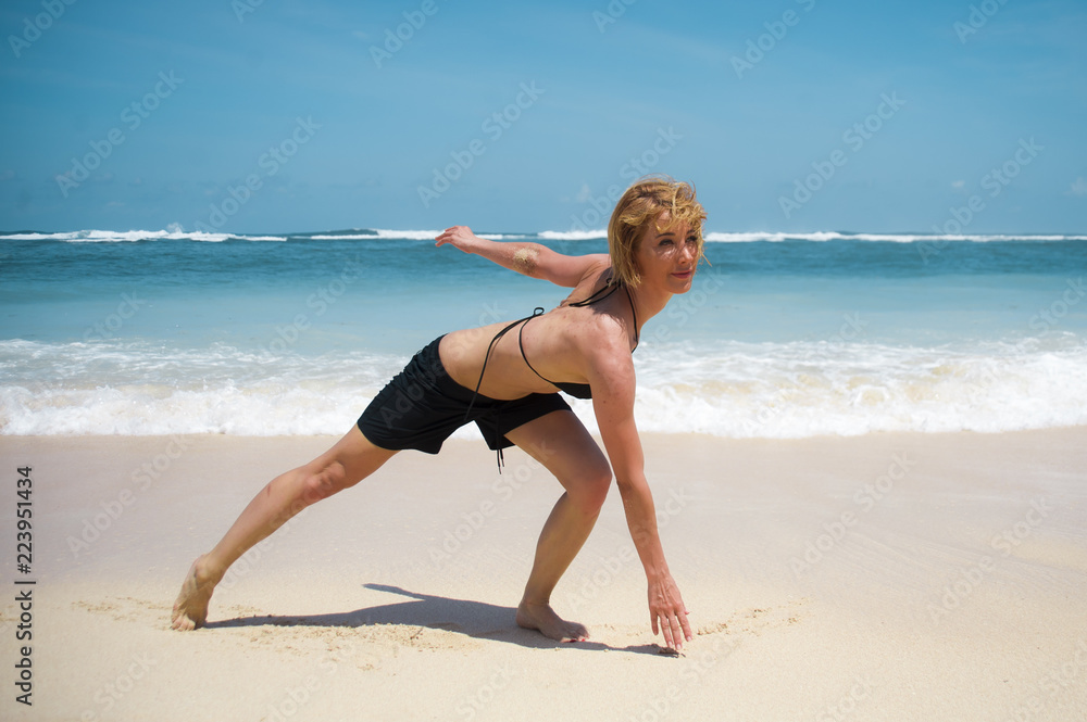 young happy and attractive sporty woman doing fitness exercise on tropical paradise beach enjoying summer cardio workout isolated on beautiful vivid turquoise sea young happy and attractive sporty woman doing fitness exercise on tropical paradise beach enjoying summer cardio workout isolated on beautiful vivid turquoise sea