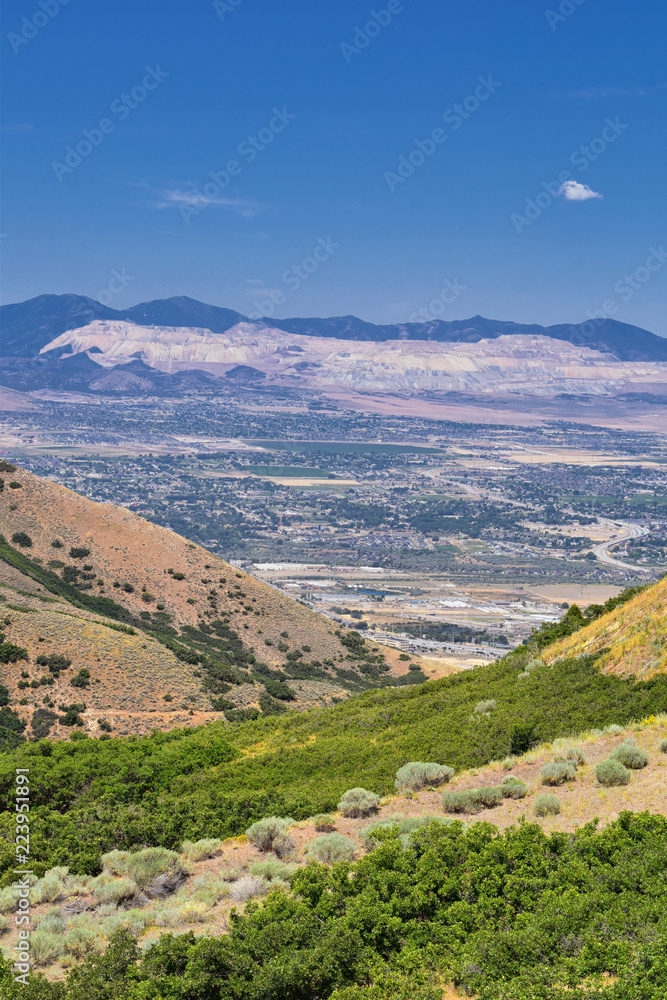 Panoramic Landscape view of Wasatch Front Rocky and Oquirrh Mountains, Rio Tinto Bingham Copper Mine, Great Salt Lake Valley in summer with Cloudscape. Utah, USA.