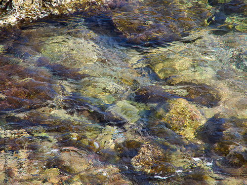 Clear blue sea ocean water over rocks