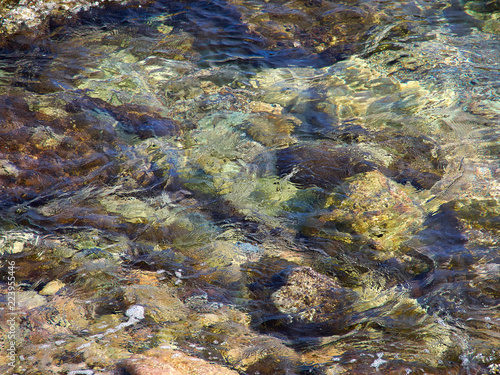 Clear blue sea ocean water over rocks