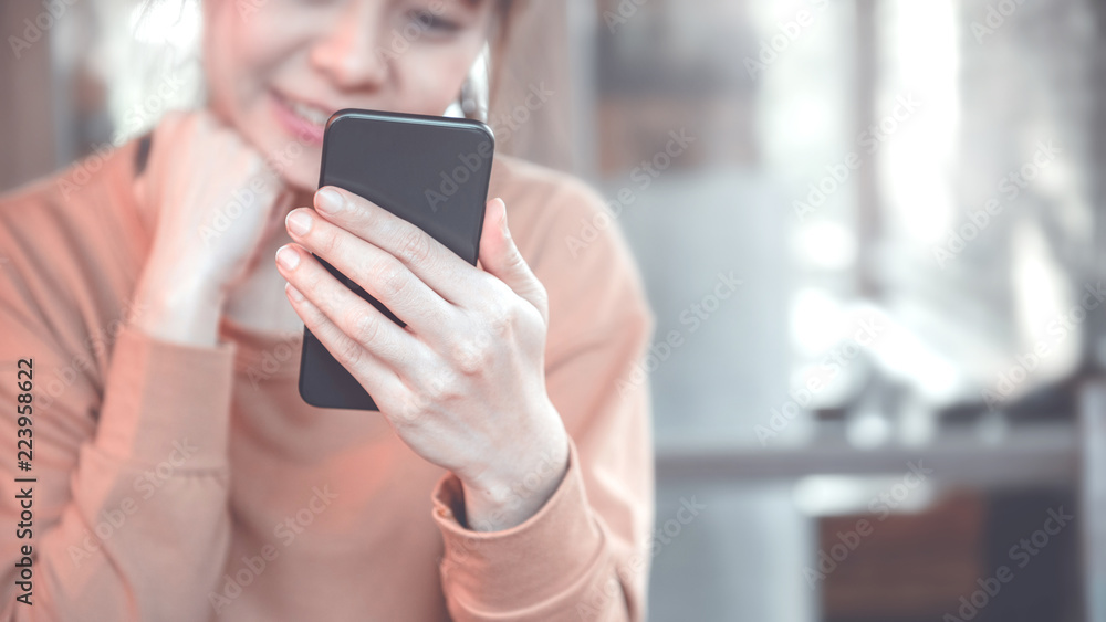Happy female using smartphone at modern coffee shop, she working or playing social network on mobile. Happy female using smartphone at modern coffee shop, she working or playing social network on mobile.